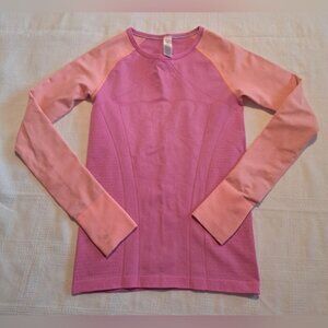 Ivivva girls size 12 long sleeve shirt, pink and orange, thumb holes cuff defect